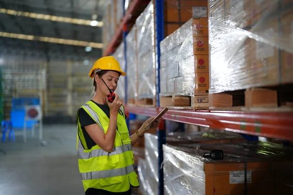 stock image Warehouse worker working in the large logistic distribution warehouse. Worker in reflective clothing working in the warehouse