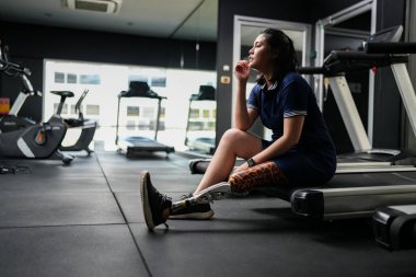 Spor salonunda protez bacaklı engelli bir sporcunun portresi.