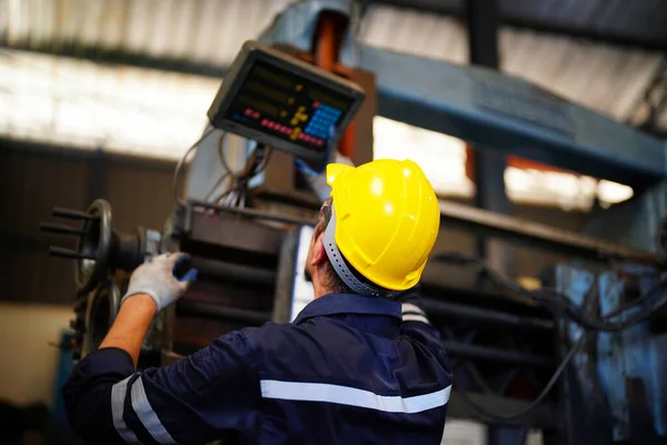 stock image Lathe Operator Concentrated on Work. Worker in uniform and helmet works on lathe, factory. Industrial production, metalwork engineering, manufacturing.