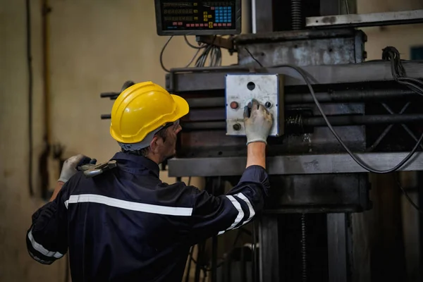 stock image Lathe Operator Concentrated on Work. Worker in uniform and helmet works on lathe, factory. Industrial production, metalwork engineering, manufacturing.