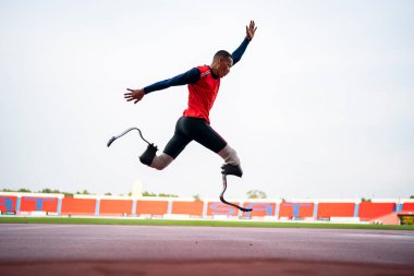 Sporcu fiziksel olarak engelli, stadyum yolunda koşuyor.