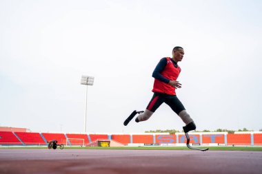 Sporcu fiziksel olarak engelli, stadyum yolunda koşuyor.