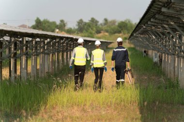 Fotovoltaik güneş panellerinin temizliğini kontrol eden mühendisler yenilenebilir enerji için fotovoltaik modülleri olan mühendisler