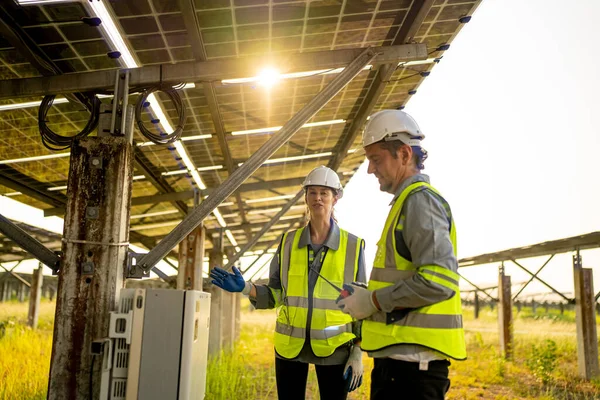 Engineers  installing and checking an operation of sun and cleanliness of photovoltaic solar panels