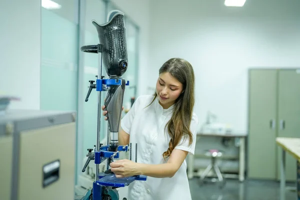 stock image Orthopedic technician making prosthetic leg for disabilities people in workshop.