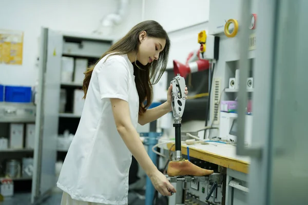 stock image Orthopedic technician making prosthetic leg for disabilities people in workshop.