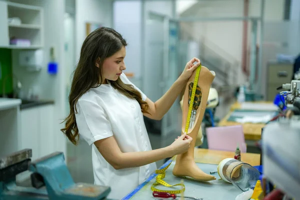 stock image Orthopedic technician making prosthetic leg for disabilities people in workshop.