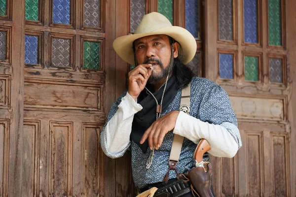 stock image Brutal cowboy with revolver, gunfight on texas ranch, western