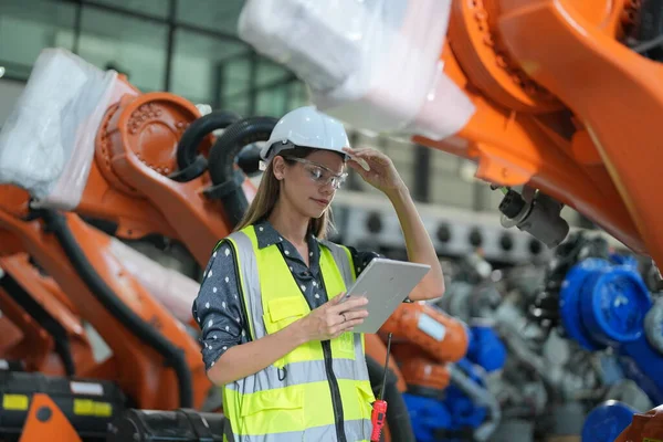 stock image Robotic Arm engineer checking  equipment with software of an Artificial Intelligence, Programming development technology work