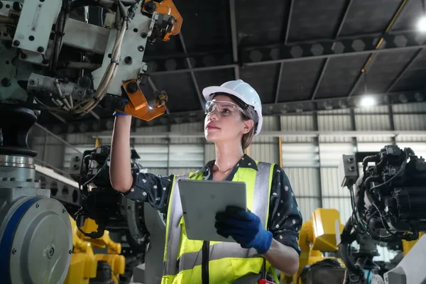 Stock image Robotic Arm engineer check on equipment in its with software of an Artificial Intelligence, Programming development technology work