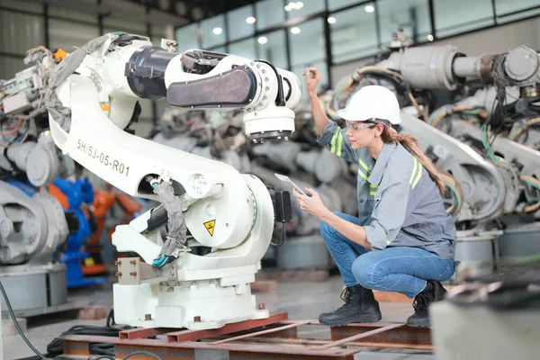 stock image Robotic Arm engineer check on equipment in its with software of an Artificial Intelligence, Programming development technology work