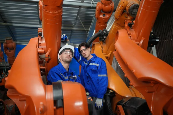 stock image Robotic Arm engineers checking equipment of an Artificial Intelligence Computer Processor Unit