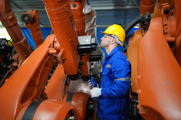 Robotic Arm engineer check on equipment in its with software  of an Artificial Intelligence Computer Processor Unit