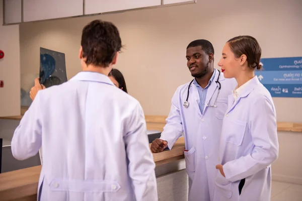 stock image doctors examining x-ray in corridor of hospital