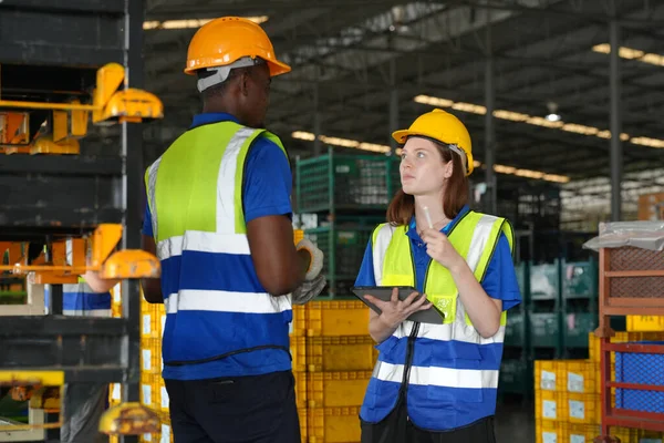 Warehouse Industrial supply chain and Logistics Companies inside. Warehouse workers checking the inventory. Products on inventory shelves storage. Workers Doing Inventory in Warehouse.