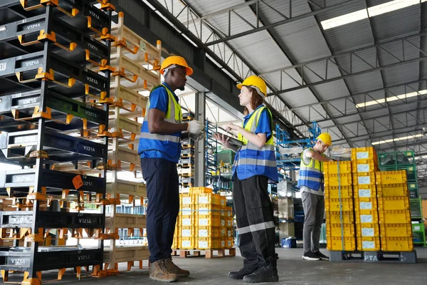 Warehouse Industrial supply chain and Logistics Companies inside. Warehouse workers checking the inventory. Products on inventory shelves storage. Workers Doing Inventory in Warehouse.