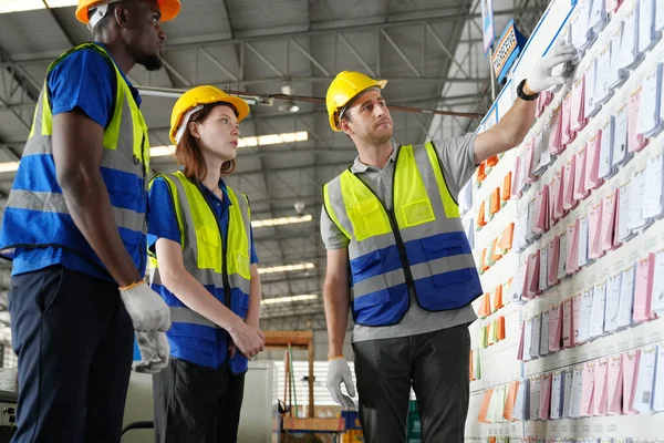 Warehouse Industrial supply chain and Logistics Companies inside. Warehouse workers. Products on inventory shelves storage. Workers Doing Inventory in Warehouse.