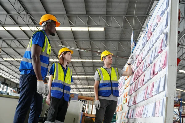 Warehouse Industrial supply chain and Logistics Companies inside. Warehouse workers checking the inventory. Products on inventory shelves storage. Workers Doing Inventory in Warehouse.