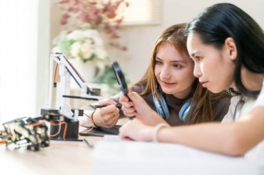 Eğitim konsepti. Laboratuvarda robot yapan kızlar