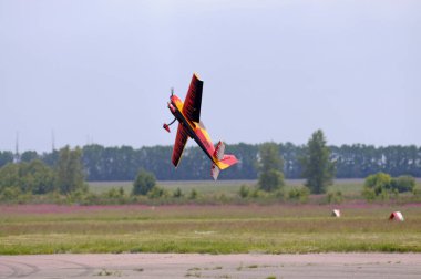 Radio controlled plane flying in the sky performing aerobatics. Kyiv, Ukraine