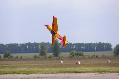 Radio controlled plane flying in the sky performing aerobatics. Kyiv, Ukraine