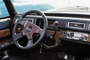 Interior of an old car: steering wheel, dashboard, glove compartment, seats. Festival OLD CAR Land. May 12, 2019. Kyiv Ukraine