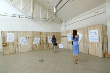 Two women visitors looking at the modern installation. Ukrainian 1st festival of Women Contemporary Art. October 25, 2018. Kyiv, Ukraine