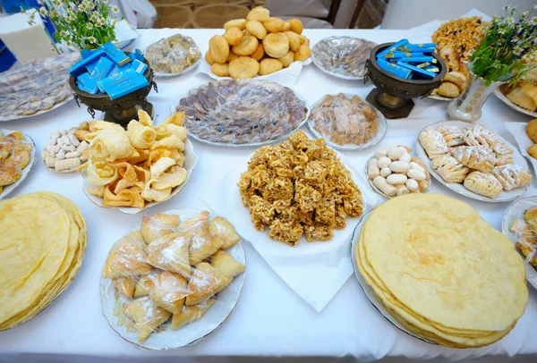 Traditional Kazakh oriental sweets put on table. Meals served during celebrating great islamic holiday Nowruz. Festival of Oriental culture. March 20, 2018. Kyiv, Ukraine
