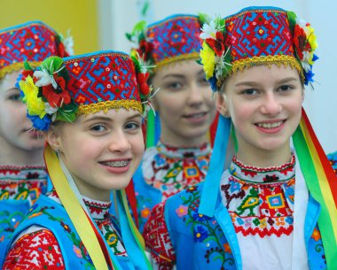 Teen girls dancers in Ukrainian national costumes waiting for performance at backstage. Festival of Oriental culture. March 20, 2018. Kyiv, Ukraine