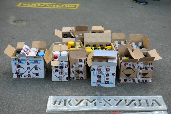 stock image  ardboard boxes with cans spray andto paint put on the asphalt of the street. Fleshmob protest against Vladimir Putin, offensive lettering. June 12, 2018. Kyiv, Ukraine