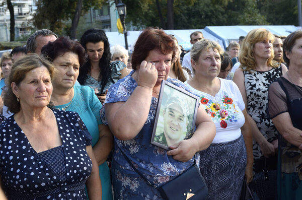 Mourning women mothers and wives crying and holding a portraits of soldiers in hands. Meeting devoted to the anniversary of the battle for Ilovaisk. August 28, 2018. Kyiv, Ukraine