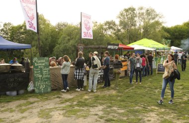 Bir şehir parkındaki sokak yemekhanelerinden fast food almak için kuyrukta bekleyen bir sürü insan. Skansen Müzik Festivali. 2 Mayıs 2016. Pyrogove, Ukrayna