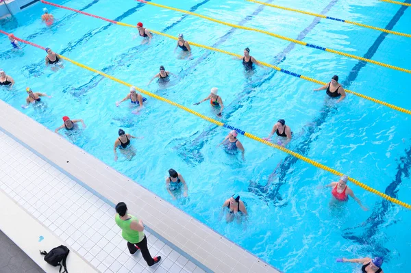 stock image Woman trainer teaching group of beginners of swimming in indoor swimming pool. October 25, 2020. Kyiv, Ukraine