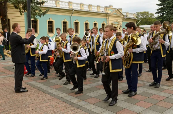 stock image Children brass orchestra playing music on a square, conductor leading. Festival of brass orchestras. August 22, 2017. Kyiv, Ukraine