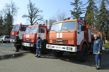 Firemen standing near fire trucks before training. April 5, 2019. Forestry of Sviatoshyn district, Kievskaya oblast, Ukraine