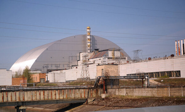 Building of a block of the Chornobyl Nuclear Power Plant, ChNPP, New Safe Confinement on a background. Chernobyl, Ukraine