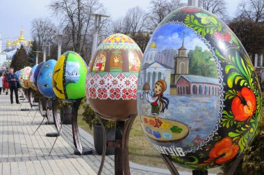 Big painted Easter eggs installations presented on the square, people walking around. Festival of Folk art. April 18, 2018. Kyiv, Ukraine