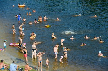Plaj, güçlü sıcaklık. Güneşlenen ve suda yüzen bir sürü insan. 10 Haziran 2021. Hidropark, Kyiv, Ukrayna