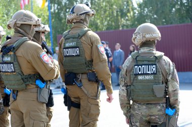 Ukrainian soldiers of KORD (police strike force, SWAT), full armor, standing in a line on a ground. September 5, 2018. Kiev, Ukraine clipart