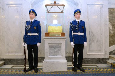 Twin soldiers in full dresses guarding Ukrainian flag in Ukrainian parliament. It was first one flied in parliament in August 24, 1991 when Ukraine took its Independence. October 7, 2018. Kyiv, Ukraine clipart