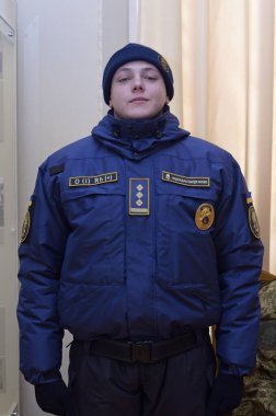 Upper part of new Ukrainian police uniform, cold-climate clothing: coat, chevron, police badge, patch with blood type. October 7, 2018. Kiev, Ukraine clipart