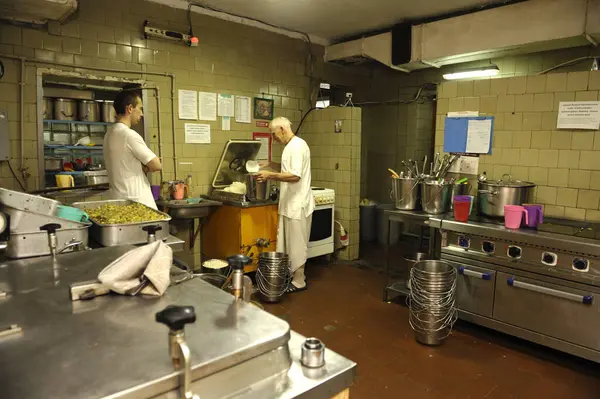 stock image Two Hare Krishna cooks in a temple kitchen cooking for parishioners Prasad - food, religious offering in Krishnaism. April 3, 2017. Kyiv, Ukraine