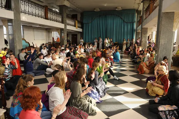 stock image Krishna followers sitting on a floor of a temple waiting for Prasad - food that is a religious offering in Krishnaism. April 3, 2017. The Krishna temple, Kiyv, Ukraine