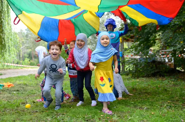 stock image Muslim Crimean Tartar children little boys girls in hijabs playing on a playground. Celebration of Hidirellez. May 19, 2018. Kiev, Ukraine
