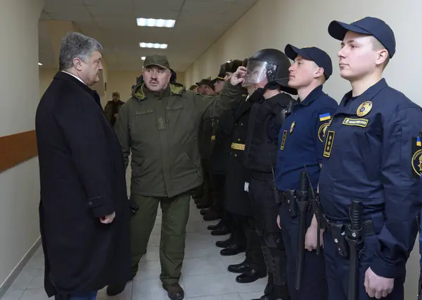 stock image At the barrack. Officer showing soldier s outfit to the President of Ukraine Petro Poroshenko. Opening International training centre of National guard of Ukraine. March 23, 2018. Staroe, Ukraine