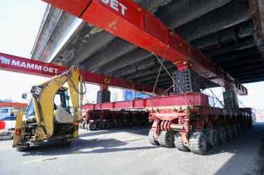 Süper Jack Mammoet onu kaldırmak için eski bir köprü bölümünü tutuyor. Shuliavskiy üst geçidinin yıkılması. 17 Nisan 2019. Kyiv, Ukrayna