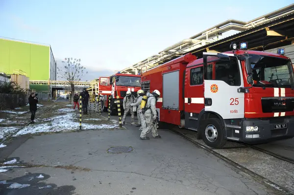 stock image Rescue team training of chemical decontamination: rescuers in protective ensembles preparing equipment to water plant territory. February 21, 2019. Kiev, Ukraine