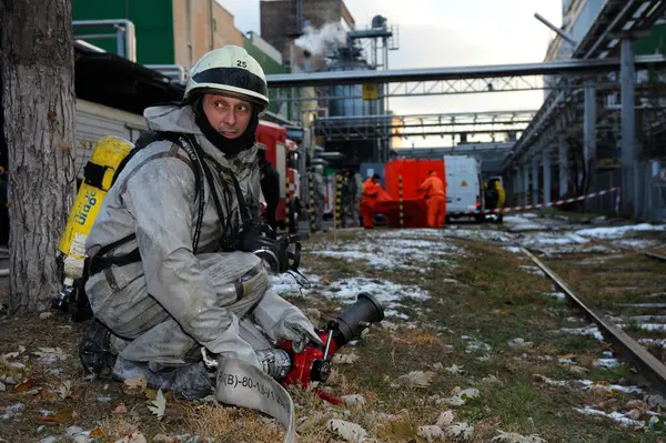 stock image Firefighters deploy firefighting equipment, fire truck is ready for watering the plant territory, training. February 21,2019. Kyiv, Ukraine