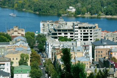 Urban view on Podilskiy district, Kyiv, Ukraine. Buildings, roofs trees and streets. clipart