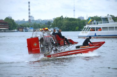 Rescue operations on a river. Rescue motorboat with lifeguards aboard floating on the water. October 7, 2021. Kiev, Ukraine clipart